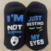 Unisex Black and white dotted eyelashes sleeping face socks i'm not sleeping just resting_maomaolike.com